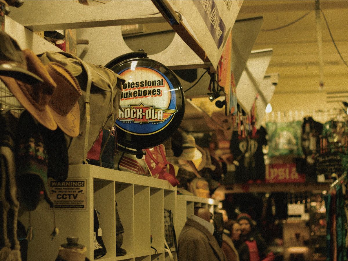 The inside of a store with multiple hats and bags on display.