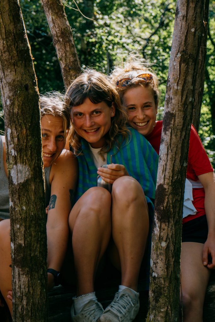 Happy Volunteers behind trees